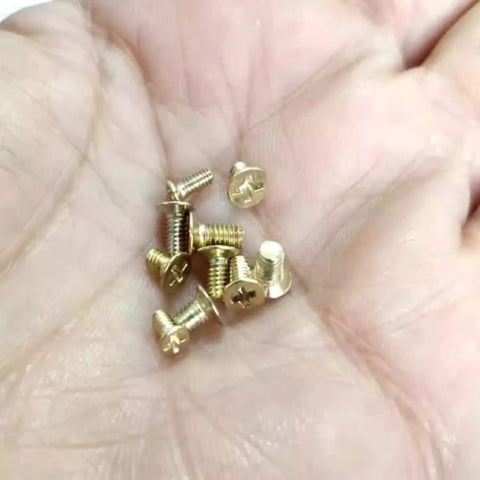 Gold Flat Head Turn Lock Screws 40 Pack Small Phillips Replacement Hardware Kit With Tool For Purses Handbags Wallet Totes Quilted Bags No Sweat Repair Set held in a hand.
