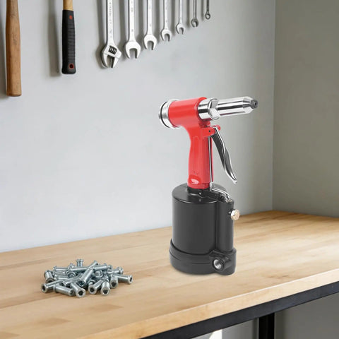 Pro Pneumatic Rivet Gun Kit With Heavy Duty Air Riveter Tool For Automotive Repair Jobs Built From Tough Stainless Steel And Durable Aluminum Alloy For Long Lasting Gutsy Performance On Every Single Job. red pneumatic rivet gun on workbench with rivets