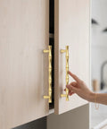 Brushed Gold Cabinet Pulls 7.5 Inch Hole Center Zinc Alloy Heavy Duty Drawer Handles 6 Pack shown on light wood cabinet
