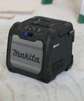 Cordless Job Site Bluetooth Speaker For Power Tools 18V LXT And 12V Max CXT Lithium Batteries on workshop floor, rugged design.