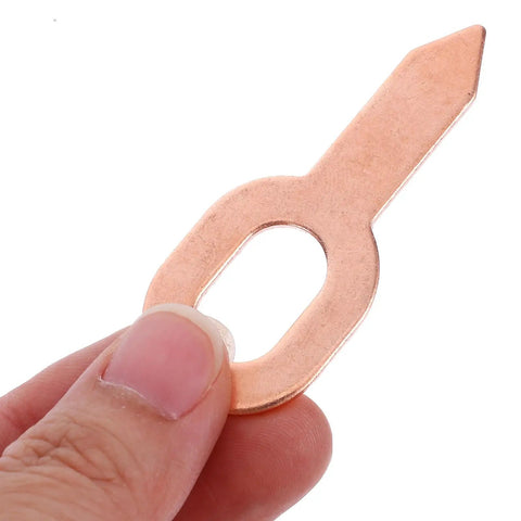 Close-up of a rose gold panel washer from Auto Dent Repair Kit With 50 Dent Puller Rings And Panel Washers, held between fingers.