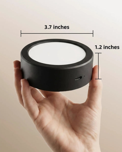Cordless Led Wall Sconce With Rechargeable Battery Dimmable Touch And Remote Controls Three Warm To Cool Temperatures 360 Degree Rotation Zero Drilling Renter Ready Upgrade That Goes Hard For Bedroom Bedside Vibes Black Pack Of Two shown in hand, measuring 3.7 inches wide and 1.2 inches high.