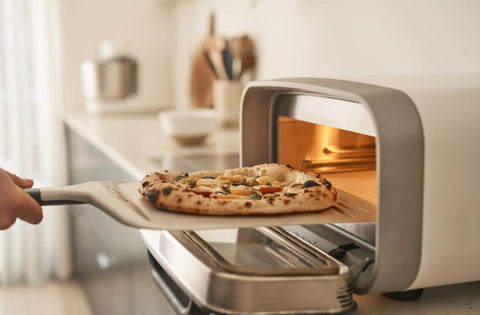 Pizza peel, 12-inch aluminum, with handle, used to slide pizza into a compact countertop oven