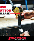 Detail of No Nonsense Retractable Ratcheting Tie Down Straps 2 Pack Black showing push button release mechanism in use.
