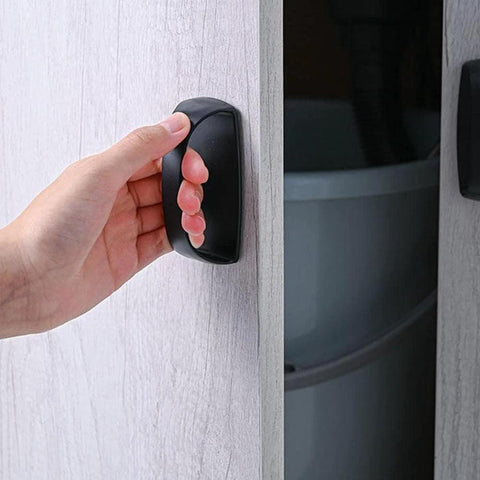 Hand pulling open cabinet with 2 Pack Self Stick Wardrobe Handles With Adhesive For Cabinets Drawers And Doors, black adhesive handle