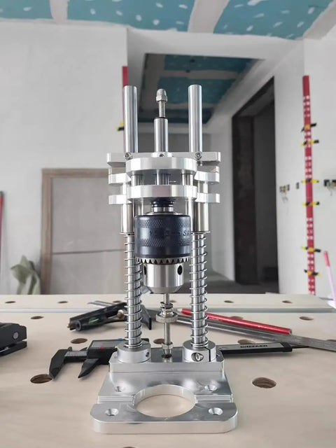 Compact Drill Press Stand With Vertical Drill Guide For Hand Drills on a workbench, featuring aluminum construction.