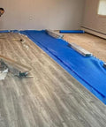 Game Changing 3in1 Vapor Barrier Flooring Underlayment With Pre Attached Tape For Laminate And Engineered Floors On Wood Or Cement Sub Floors Covers 100 Square Feet Quick Lay Down Smooth And Solid Finish during installation.