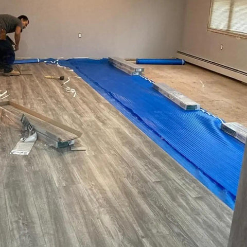 Game Changing 3in1 Vapor Barrier Flooring Underlayment With Pre Attached Tape For Laminate And Engineered Floors On Wood Or Cement Sub Floors Covers 100 Square Feet Quick Lay Down Smooth And Solid Finish during installation.