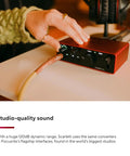 Hand adjusting controls on Scarlett Solo 4th Gen USB Audio Interface Bundle With Microphone And Guitar Preamps Studio Quality Sound 120dB Dynamic Range And 2 Year CPS Enhanced Protection Pack
