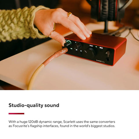 Hand adjusting controls on Scarlett Solo 4th Gen USB Audio Interface Bundle With Microphone And Guitar Preamps Studio Quality Sound 120dB Dynamic Range And 2 Year CPS Enhanced Protection Pack