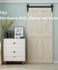 4ft Bi Folding Sliding Barn Door Hardware Kit for Two Doors installed on wall, matte black finish, home setting