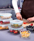 Glass Meal Prep Containers Set With Lids 18 Piece Storage Containers Airtight Leak Proof, filled with various foods and vegetables on a kitchen counter.