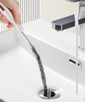 Heavy Duty Flexible Drain Snake Brush For Kicking Clogged Sink And Tub Pipes Clear, reusable tool retrieving hair from sink drain.