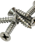 Number Twelve By One Inch Stainless Steel Wood Screws Flat Head Phillips Drive 304 Grade Rust Resistant Decking Fasteners Built Tough For Backyard Buildouts And Fence Fixes Fifty Pack laying on a white surface.