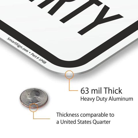 Close-up of Heavy Duty Reflective Aluminum Sign For Private Drives And Home Grounds, showing 63 mil thickness with a quarter for size reference.