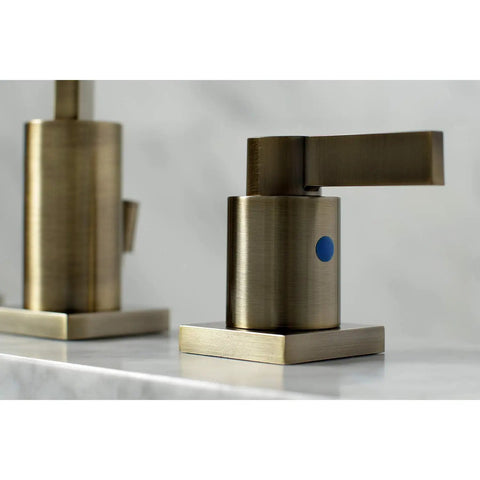 Close-up of Antique Brass Widespread Bathroom Faucet With Drip Free Ceramic Disc Cartridge Deck Mount Eight To Sixteen Inch Three Hole Installation One Point Two GPM Flow At Sixty Psi One Half Inch IPS Connection Classic Modern Blend handle.