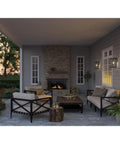 Patio scene with Endicott Collection 1 Light Outdoor Wall Lantern With Clear Seeded Glass, Craftsman Style, Textured Black on wall.