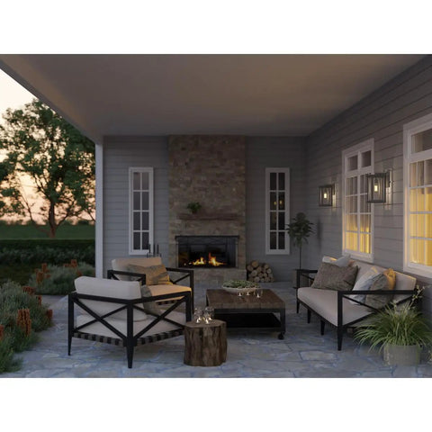 Patio scene with Endicott Collection 1 Light Outdoor Wall Lantern With Clear Seeded Glass, Craftsman Style, Textured Black on wall.