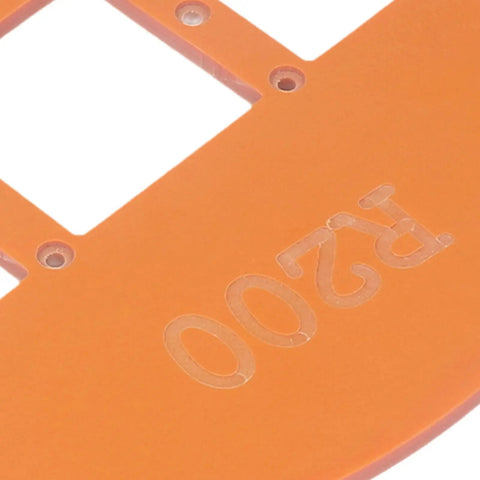 Close-up of Two Piece Woodworking Corner Radius Template Kit With Router Jig Covering R15 To R200 showing orange plastic material with cutouts.