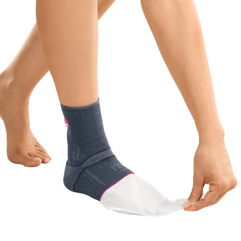 Person wearing Knit Achilles Ankle Support Brace For Men And Women With Silicone Inlays And Dual Heel Wedges, Silver