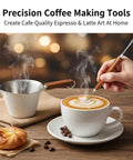 Stainless Steel 100ml Espresso Cup With Wooden Handle Wide Mouth Pour Spout V Shaped Nozzle Includes Latte Needle Great For Americano Cappuccino Latte Espresso Shots And Top Notch Measuring Cup Scale on a table with latte art and pastry.
