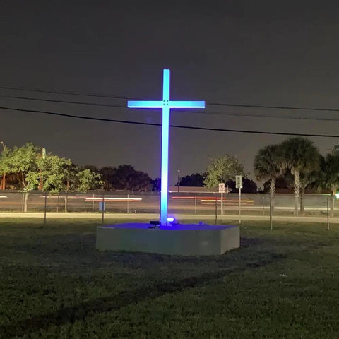 144W RGBW LED Wall Washer illuminating a large outdoor cross with blue light, showcasing color changing capabilities at night