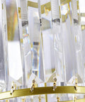 Close-up of Modern Ceiling Pendant Light Featuring Transparent Crystal And Polished Gold Cylinder Frame showing crystal details.