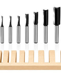 7 Piece Straight Router Bit Set With 1/4 Inch Shank Plunge Top Bearing Flush Trim Bits For DIY Woodworking Includes Cut Diameters 1/8 5/32 3/16 1/4 5/16 3/8 1/2 Inches And Heights 1/2 3/4 1 1-3/16 Inches, set on wood block