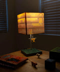 Pixelated Yellow Bee Nest Block Desk Lamp With 3D Bee Puller And LED Mood Light For Bedroom Desk Playroom Pixel Gaming Decor For Kids Room Nightstand Accent That Is Totally Lit illumines a dim desk with pixel art shade.