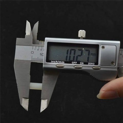 Measuring M2.5 Nylon Hex Standoff And PCB Spacer 100 Piece Pack White 94V2 Flame Resistant with calipers at 10.27mm.