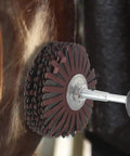 Close-up of Seven Pack Abrasive Cloth Flap Wheel With One Quarter Inch Shank 80mm Diameter For Woodworking Root Carving And Furniture Polishing Grits 80 120 150 180 240 320 400 in use on wood surface