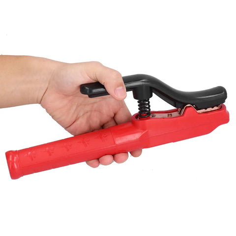 Heavy Hitter Welding Electrode Clamp, 1000A Copper Jaw Stinger with rubberized grip, held in hand, adjustable angle.