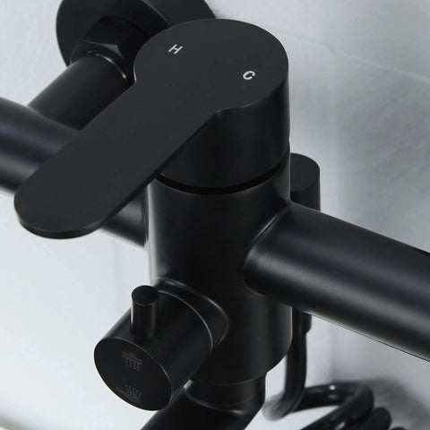 Close-up of matte black wall mount kitchen faucet control, part of heavy duty stainless steel commercial mixer tap