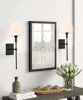 Living room with Slim Wall Sconce Set Of 2 With White Fabric Shades In Black Finish, next to framed art and decor, 23.7 inch tall