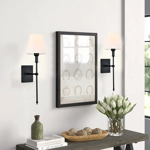 Living room with Slim Wall Sconce Set Of 2 With White Fabric Shades In Black Finish, next to framed art and decor, 23.7 inch tall