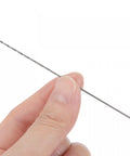 Close-up of a hand holding one piece from the 10 Piece 0.9mm Mini Micro Twist Drill Bits Set in High Speed Steel with Straight Shank
