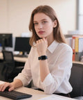 Person in office wearing Dope Vivid Silicone Band Keeper With Magic Band Locks And Clips on smartwatch