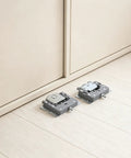 Smooth Sliding Closet Door Rollers With Built In Damping for Wooden Wardrobe Panels shown near beige cabinet doors.