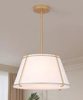 16" White and Gold Drum Pendant Light with Metal Lantern Fabric Shade hanging from ceiling with gold accents.
