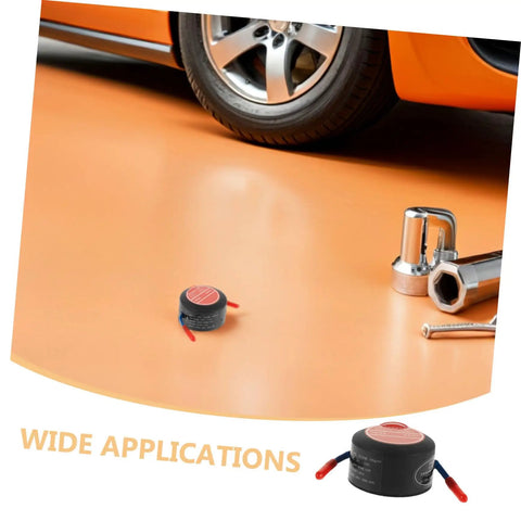 Low Key No Stress Automatic Aerosol Fire Extinguisher 2 Pack With Heavy Duty Back Adhesive Auto Extinguishing Patch For Engine Bay Vehicle Fire Suppression And Garage Safety Gear on the floor near a vehicle tire.