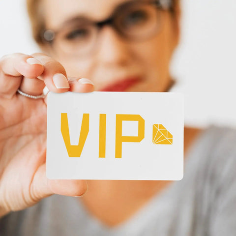 Person holding a white PVC card with 'VIP' printed in yellow; straight up premium white PVC cards 85x54mm for ID badges.