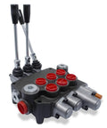 Angled front view of a monoblock hydraulic directional control valve, 3-spool with levers, gray body and red port caps