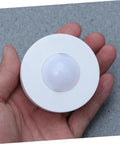 Hand holding a single light from Six Pack LED Cabinet Lights Set With Dimmable Warm White Under Cabinet Lighting For Cupboards Kitchen And Office Use Touch Control Dimmer And Easy Install For Adjustable Brightness