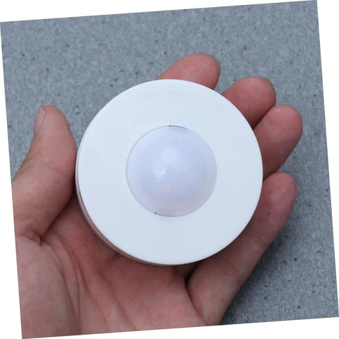 Hand holding a single light from Six Pack LED Cabinet Lights Set With Dimmable Warm White Under Cabinet Lighting For Cupboards Kitchen And Office Use Touch Control Dimmer And Easy Install For Adjustable Brightness