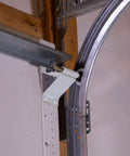 All In One Garage Door Repair Kit For 16x7 White Doors With Powder Coated Hinges And Brackets Quiet Operation Rust Resistant Thicker Gauge Parts Easy Tune Up For Smoother More Reliable Garage Door Performance showing installed bracket and track