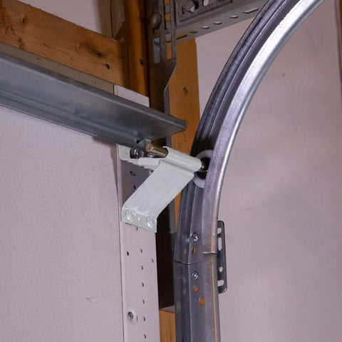 All In One Garage Door Repair Kit For 16x7 White Doors With Powder Coated Hinges And Brackets Quiet Operation Rust Resistant Thicker Gauge Parts Easy Tune Up For Smoother More Reliable Garage Door Performance showing installed bracket and track