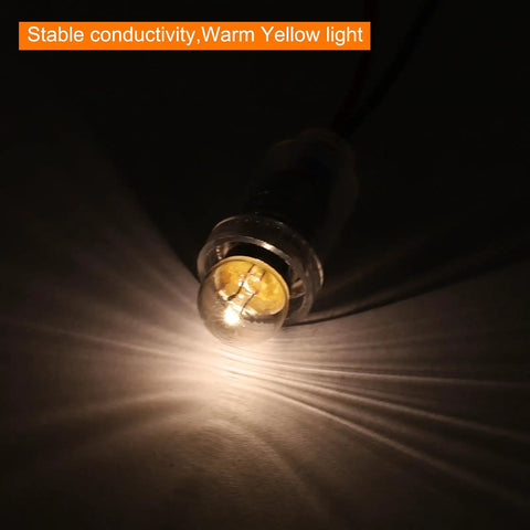 Hella Bright E10 Mini Light Bulbs With Warm Yellow Vibe 10 Pack 1.5V Miniature Screw Bulbs glowing in a dark setting.