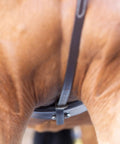 Close-up view of adjustable leather standing martingale on a pony, showing stainless steel hardware, chocolate brown color.