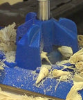 KHI Hinge Concealed Jig And KHC Premium Face Clamp Set in use, cutting wood shavings, blue pro grade tool for precise joints