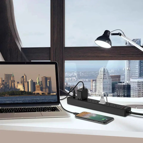 Six Outlet Power Strip With Three USB Ports, 6 Ft Cord, 1680J Surge Protector, Widely Spaced Outlets, USB A And USB C Fast Charge, Overload Shield, Great For Desk, Home Office, And Entertainment Setup on desk with laptop and phone